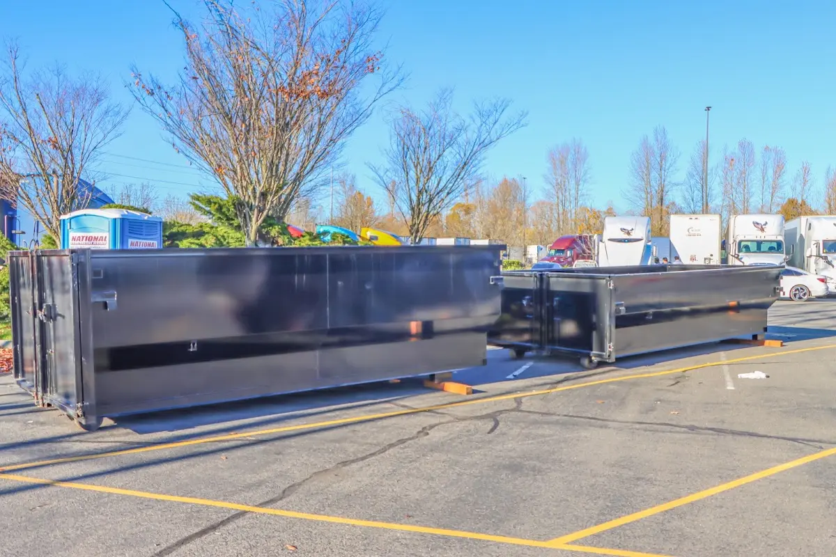 Professional dumpster rental service with roll-off container on residential driveway in Carteret